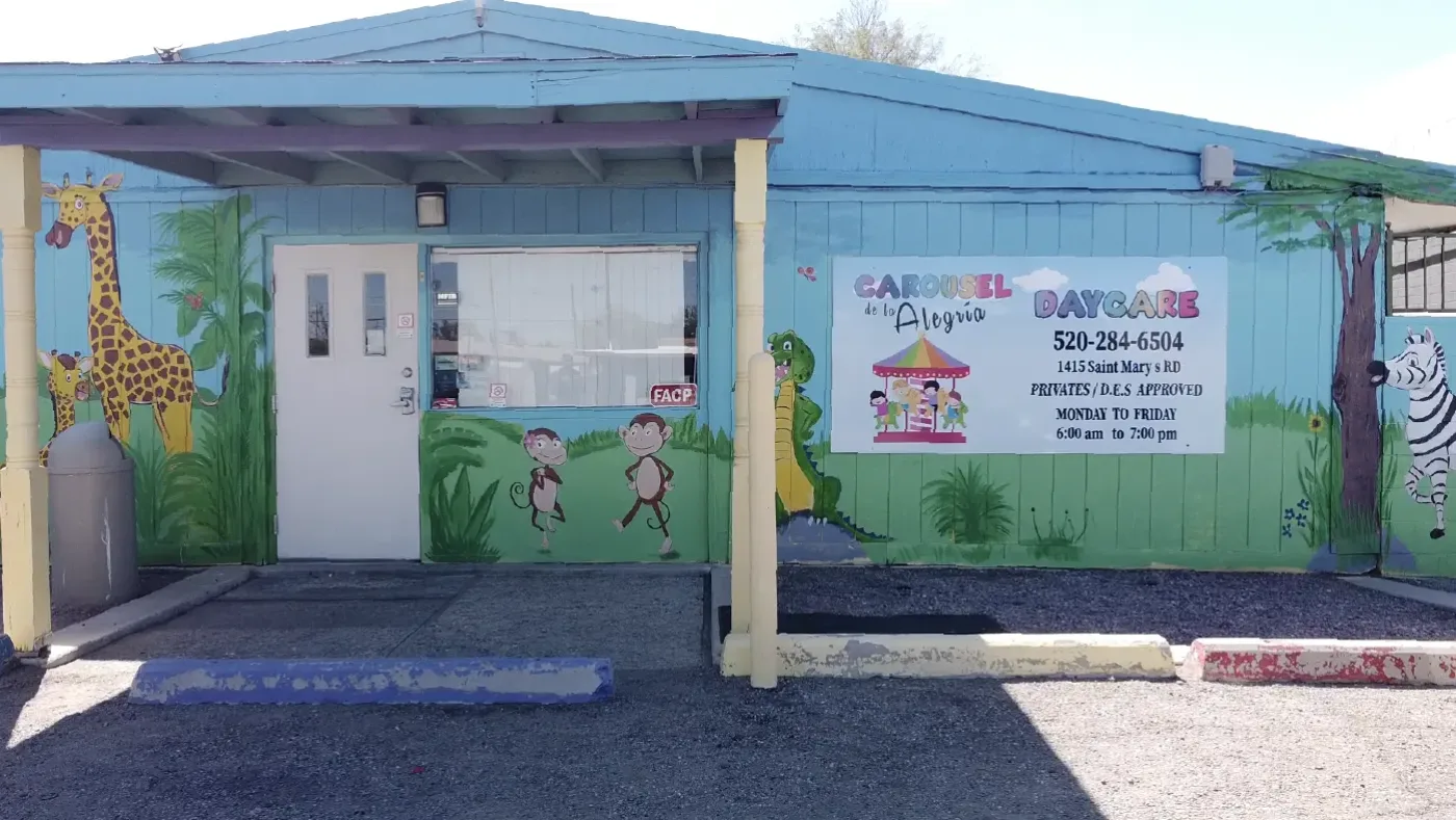 The front entrance of Happy Carousel Daycare in Tucson, with its hand-painted Carousel de la Alegría mural